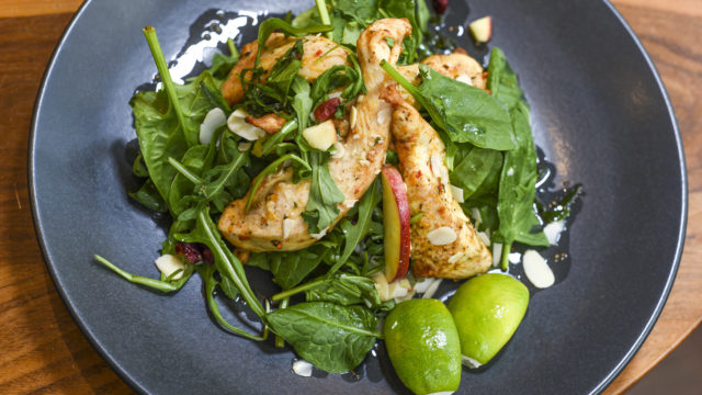 Asian style chicken on a bed of fresh greens