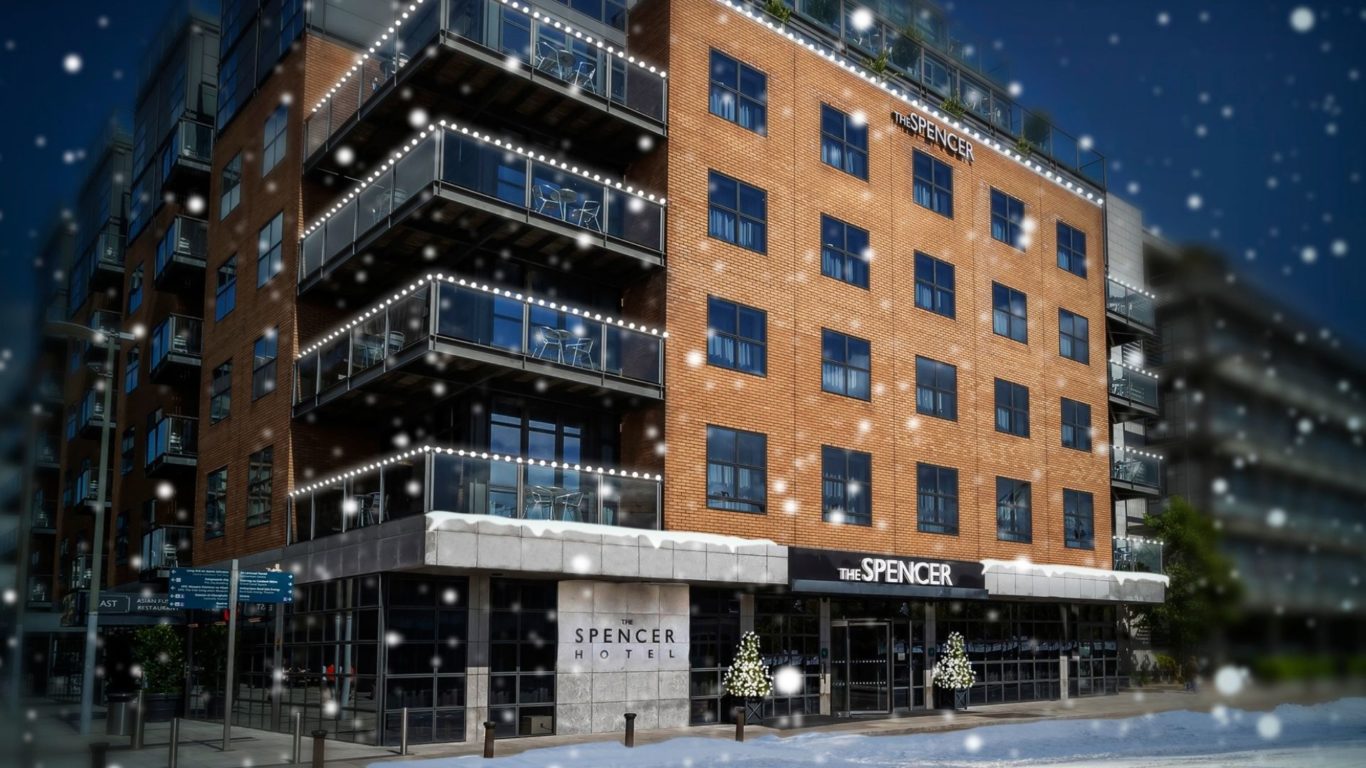 Exterior of the Spencer Hotel Winter with snow and Christmas Trees