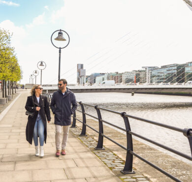 Couple enjoying a peaceful stroll by the River Liffey, just moments from The Spencer Hotel.