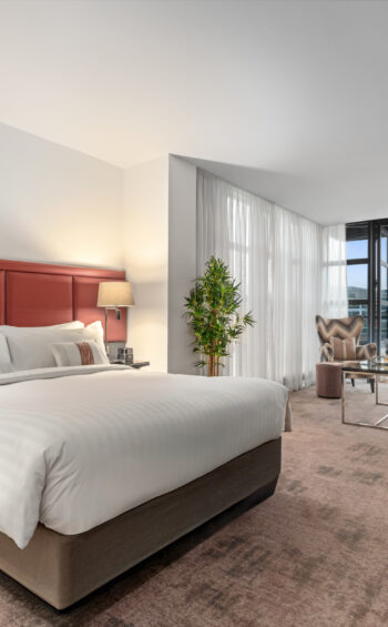 Stylish Junior Suite with king bed, separate seating area, and private balcony — perfect for a luxurious Dublin stay at The Spencer Hotel.