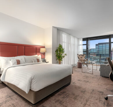 Stylish Junior Suite with king bed, separate seating area, and private balcony — perfect for a luxurious Dublin stay at The Spencer Hotel.