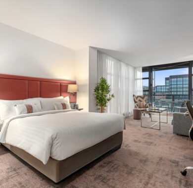 Stylish Junior Suite with king bed, separate seating area, and private balcony — perfect for a luxurious Dublin stay at The Spencer Hotel.