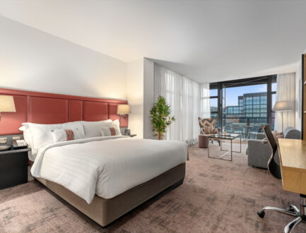 Stylish Junior Suite with king bed, separate seating area, and private balcony — perfect for a luxurious Dublin stay at The Spencer Hotel.