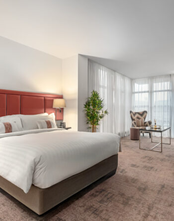 Stylish Junior Suite with king bed, separate seating area, and private balcony — perfect for a luxurious Dublin stay at The Spencer Hotel.