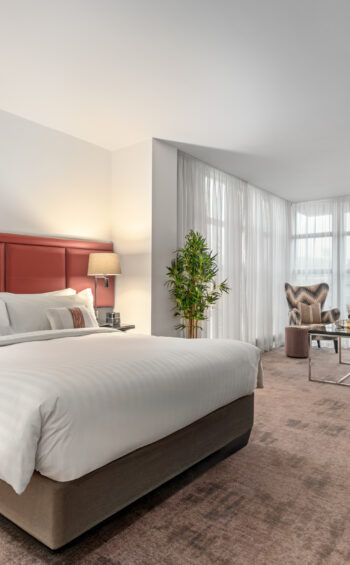 Stylish Junior Suite with king bed, separate seating area, and private balcony — perfect for a luxurious Dublin stay at The Spencer Hotel.
