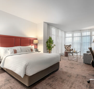 Stylish Junior Suite with king bed, separate seating area, and private balcony — perfect for a luxurious Dublin stay at The Spencer Hotel.