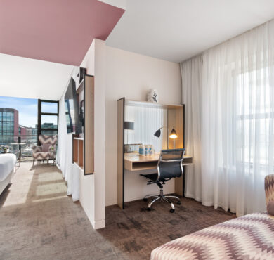 Stylish Junior Suite with king bed, separate seating area, and private balcony — perfect for a luxurious Dublin stay at The Spencer Hotel.