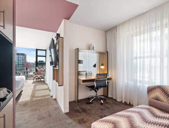 Stylish Junior Suite with king bed, separate seating area, and private balcony — perfect for a luxurious Dublin stay at The Spencer Hotel.