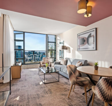 Stylish Junior Suite with king bed, separate seating area, and private balcony — perfect for a luxurious Dublin stay at The Spencer Hotel.