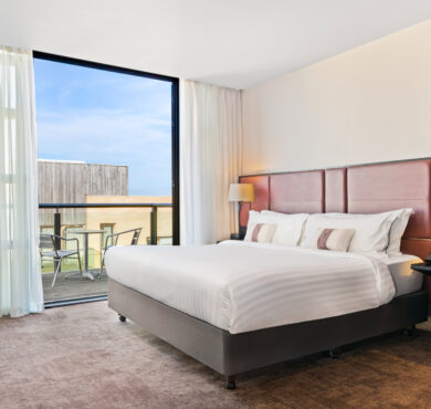 Stylish Junior Suite with king bed, separate seating area, and private balcony — perfect for a luxurious Dublin stay at The Spencer Hotel.
