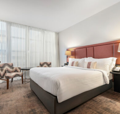Spacious Superior Room with double bed, two chairs and table, and a work desk — ideal for relaxing or working during your stay at The Spencer Hotel in Dublin City Centre.