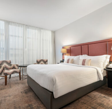 Spacious Superior Room with double bed, two chairs and table, and a work desk — ideal for relaxing or working during your stay at The Spencer Hotel in Dublin City Centre.