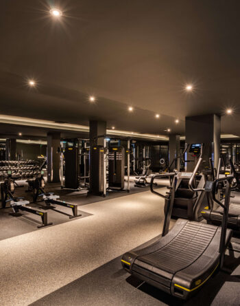 Modern hotel gym with state-of-the-art equipment, perfect for fitness enthusiasts staying in comfortable luxury.