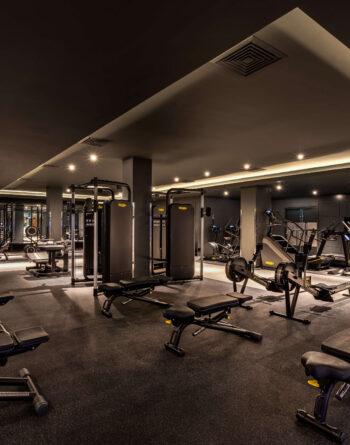 Modern hotel fitness centre with state-of-the-art gym equipment and inviting ambience for a revitalising workout.