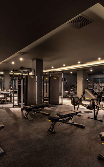 Modern hotel fitness centre with state-of-the-art gym equipment and inviting ambience for a revitalising workout.