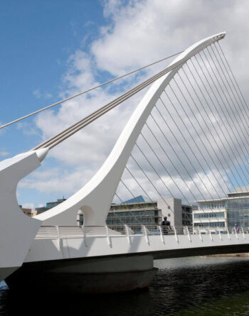 Stylish modern bridge view from riverside city hotel near cultural attractions and shopping.