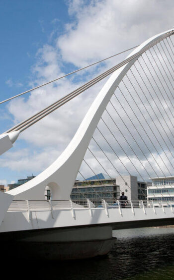 Stylish modern bridge view from riverside city hotel near cultural attractions and shopping.