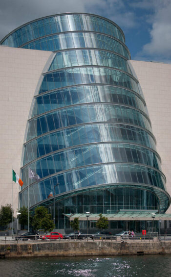 Modern hotel with unique glass architecture by the river, offering luxury accommodation and stunning city views.