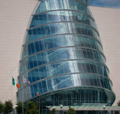 Modern hotel with unique glass architecture by the river, offering luxury accommodation and stunning city views.